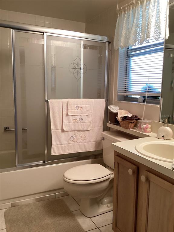 4529 Whitton Way, Unit 214 New Port Richey, FL 34653 - Photo 22 of 45 a bathroom with a granite countertop sink mirror vanity and toilet