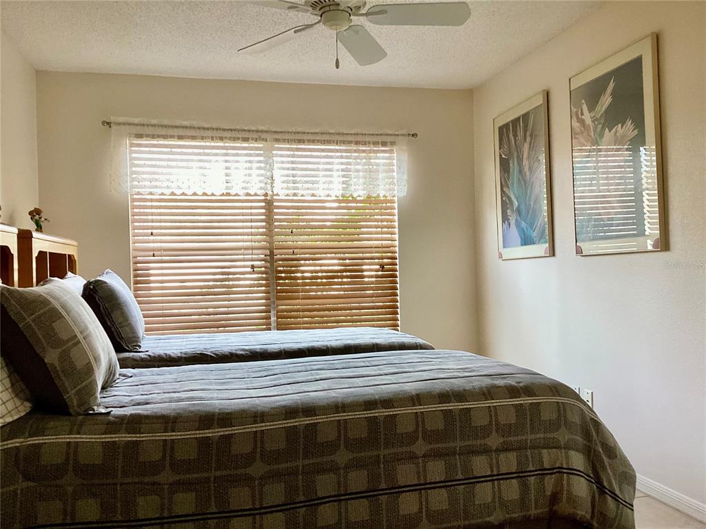 4529 Whitton Way, Unit 214 New Port Richey, FL 34653 - Photo 23 of 45 a bedroom with a bed and a window
