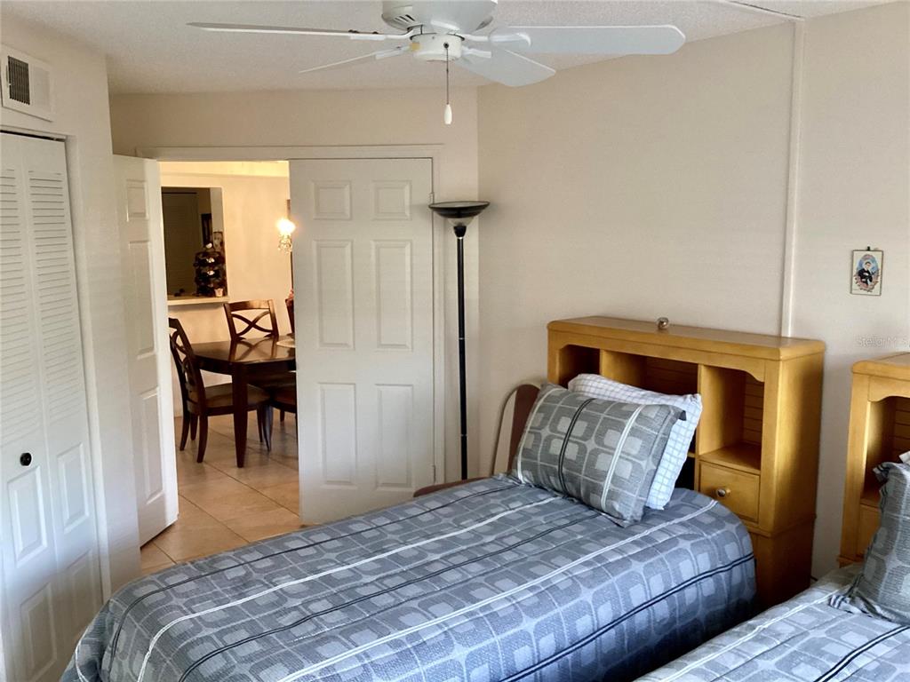 4529 Whitton Way, Unit 214 New Port Richey, FL 34653 - Photo 24 of 45 a bedroom with a bed and a chandelier