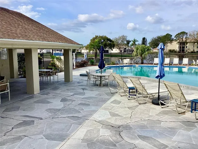a view of a swimming pool and lounge chairs