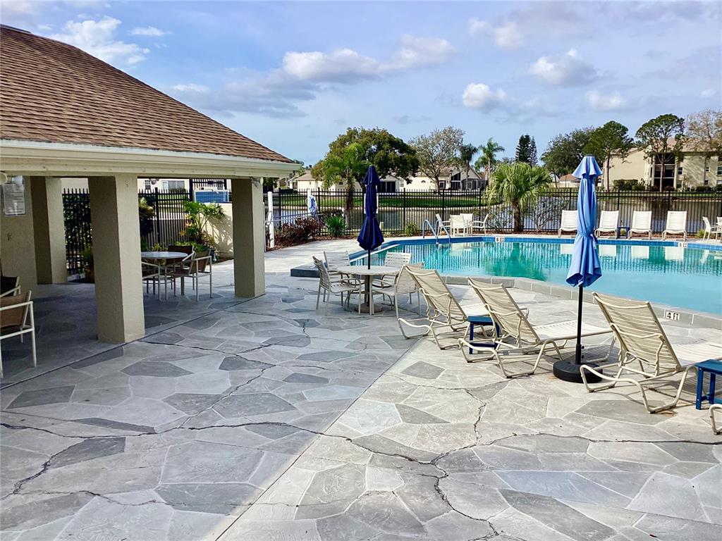 4529 Whitton Way, Unit 214 New Port Richey, FL 34653 - Photo 35 of 45 a view of a swimming pool and lounge chairs