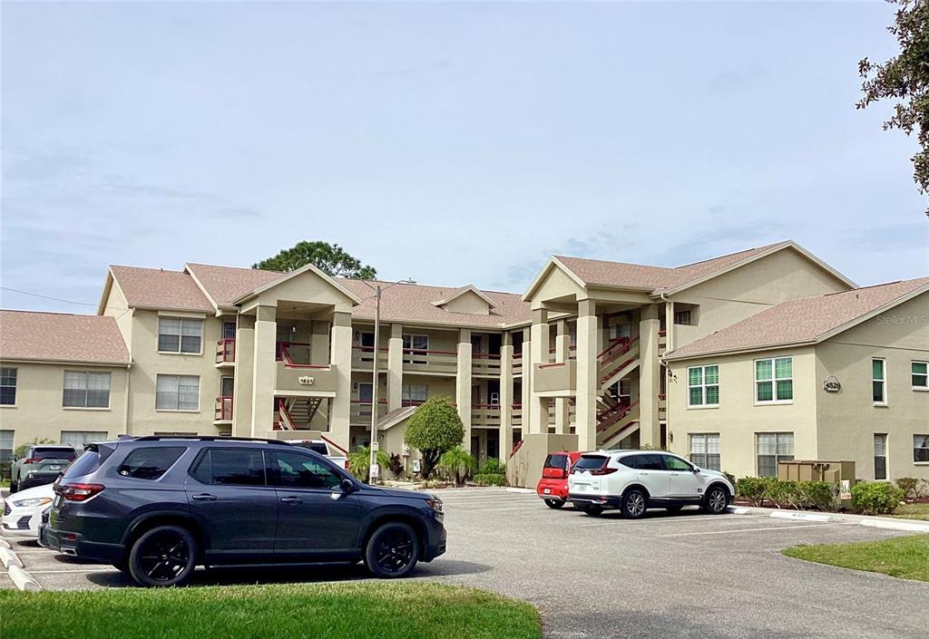4529 Whitton Way, Unit 214 New Port Richey, FL 34653 - Photo 37 of 45 a car parked in front of a big house