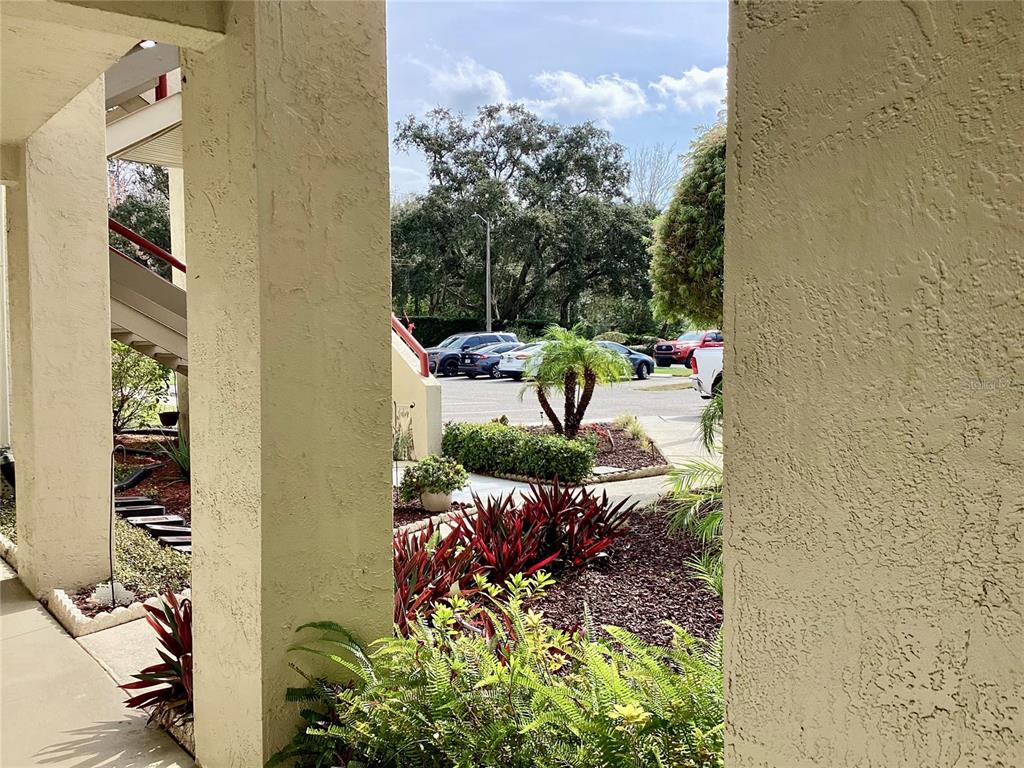 4529 Whitton Way, Unit 214 New Port Richey, FL 34653 - Photo 40 of 45 a view of a backyard with plants and a bench