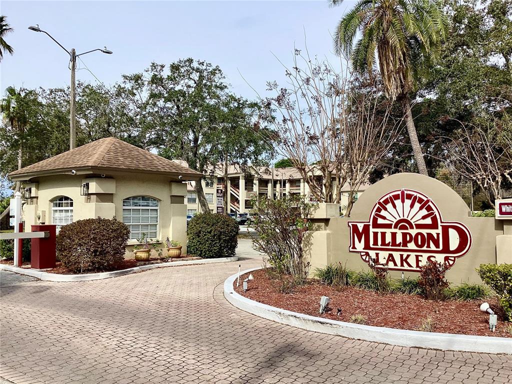 4529 Whitton Way, Unit 214 New Port Richey, FL 34653 - Photo 41 of 45 a front view of a house with a yard and garage