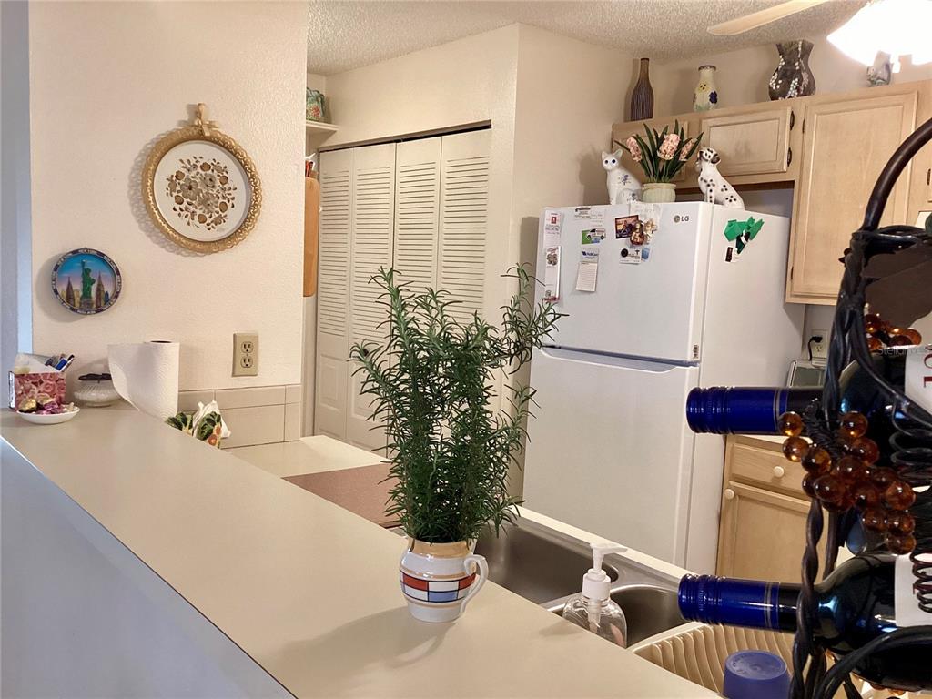 4529 Whitton Way, Unit 214 New Port Richey, FL 34653 - Photo 9 of 45 a dining room with furniture and a clock