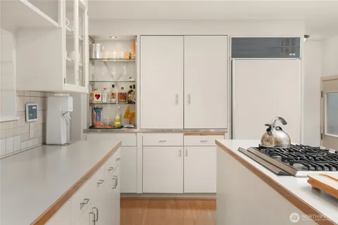a kitchen with stainless steel appliances a refrigerator and cabinets