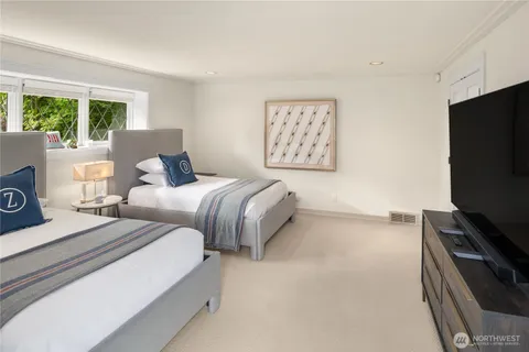 a bedroom with two beds and a flat screen tv