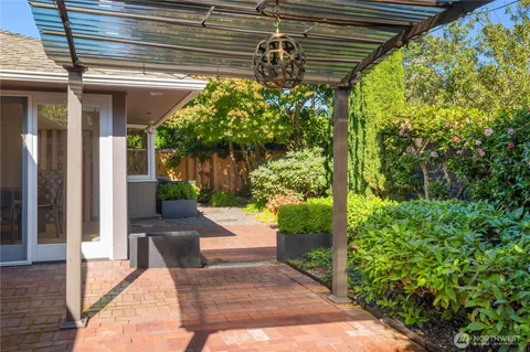 a front view of a house with plants