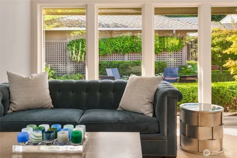 a living room with furniture and a floor to ceiling window