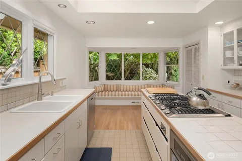 a kitchen with a sink a stove and a window