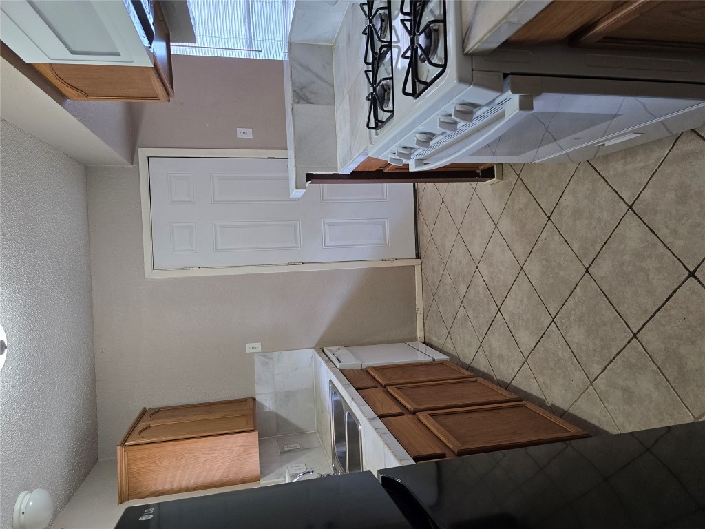 16922 Whitebrush Loop Austin, TX 78717 - Photo 7 of 10 a kitchen with a stove and a refrigerator