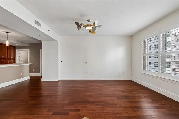 a view of a room with wooden floor and chandelier