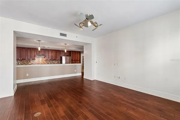 a large kitchen with stainless steel appliances granite countertop a lot of counter space and wooden floors