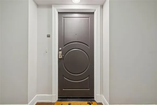 a room with a washing machine and mirror