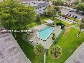 an aerial view of a house with a garden and swimming pool