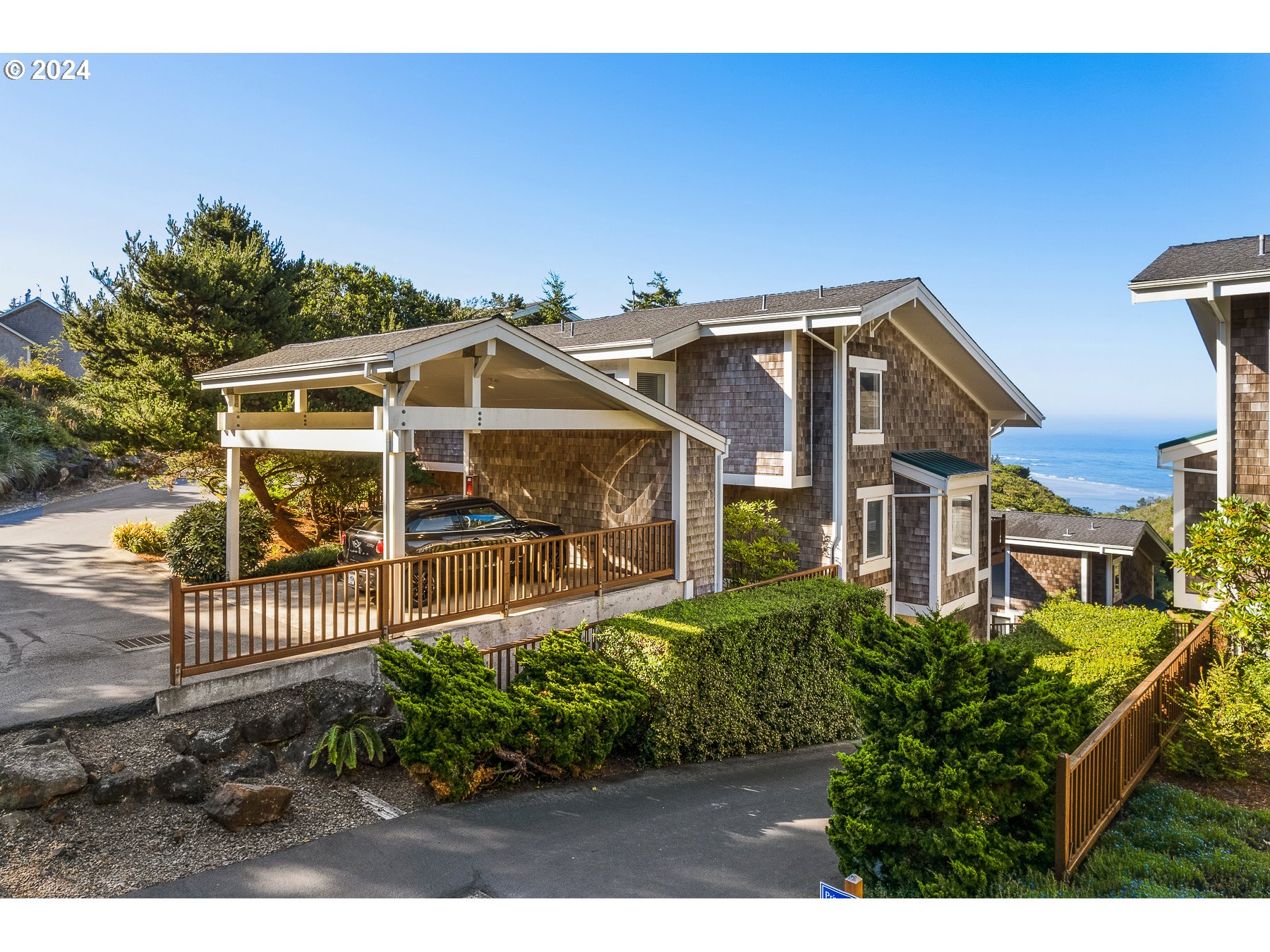 505 Capes Drive, Unit 5 Oceanside, OR 97141 - Photo 1 of 37 a front view of a house with a yard