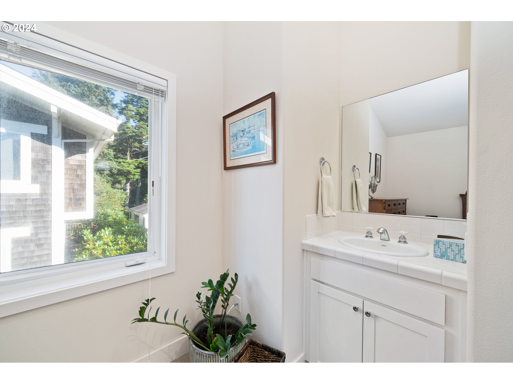 505 Capes Drive, Unit 5 Oceanside, OR 97141 - Photo 25 of 37 a bathroom with a sink a vanity and a mirror