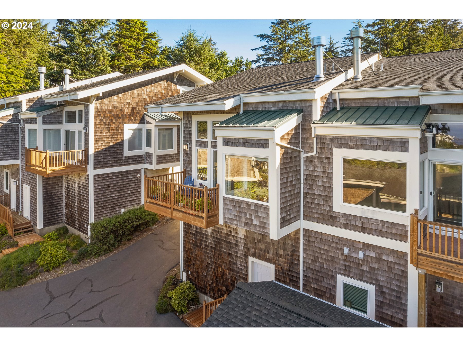 505 Capes Drive, Unit 5 Oceanside, OR 97141 - Photo 27 of 37 a view of a brick house with a large windows