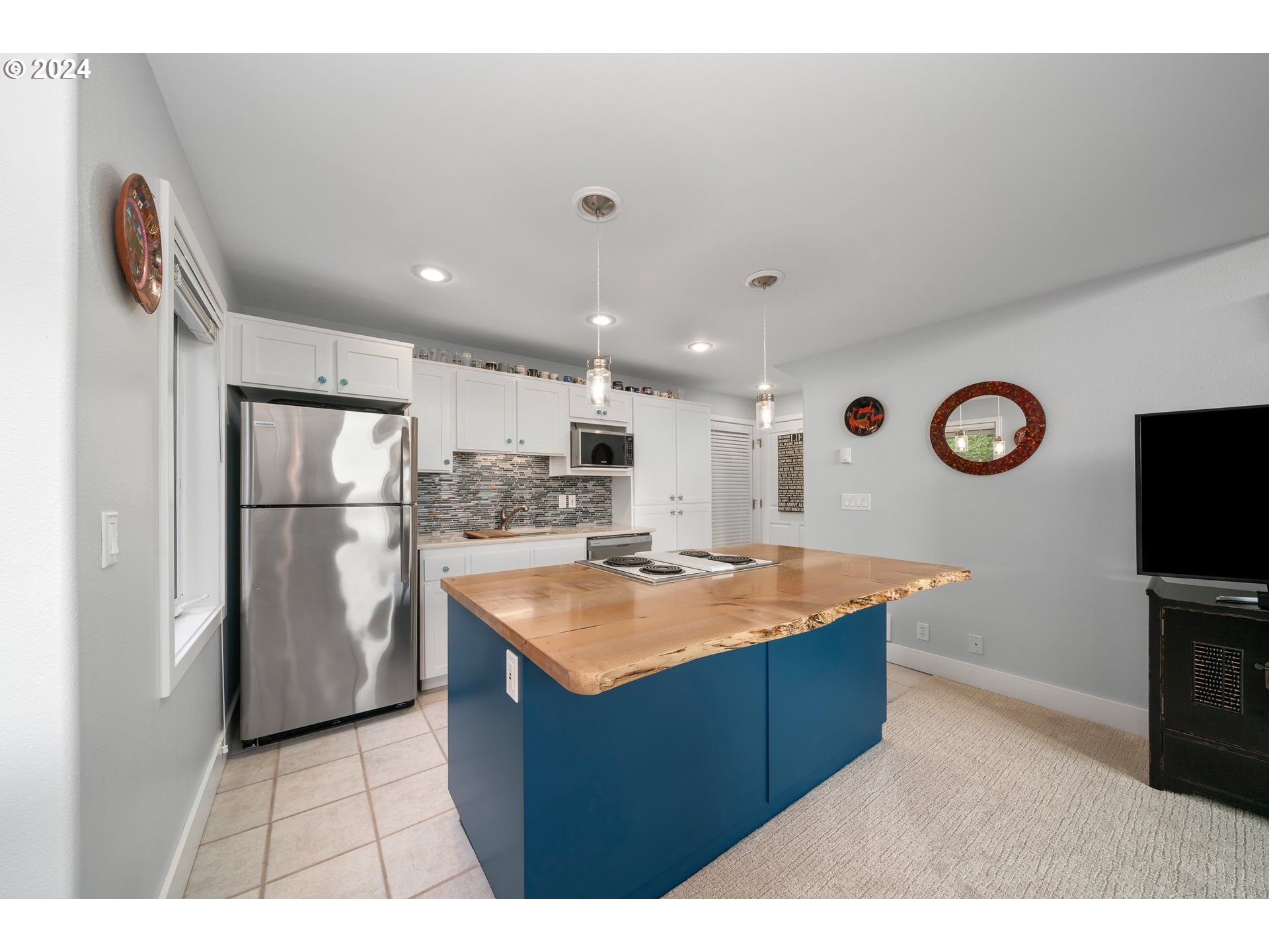 505 Capes Drive, Unit 5 Oceanside, OR 97141 - Photo 7 of 37 a kitchen with stainless steel appliances granite countertop a refrigerator a stove and a sink