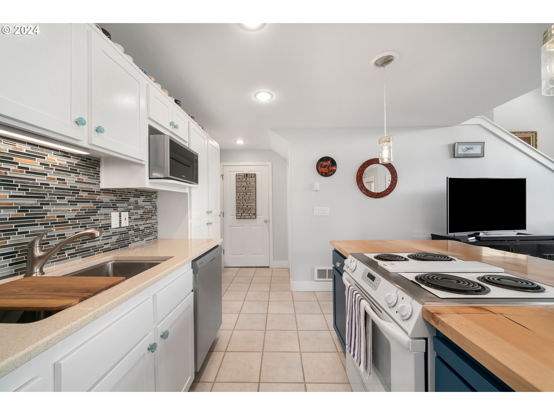 505 Capes Drive, Unit 5 Oceanside, OR 97141 - Photo 9 of 37 a kitchen that has a sink a stove and a microwave