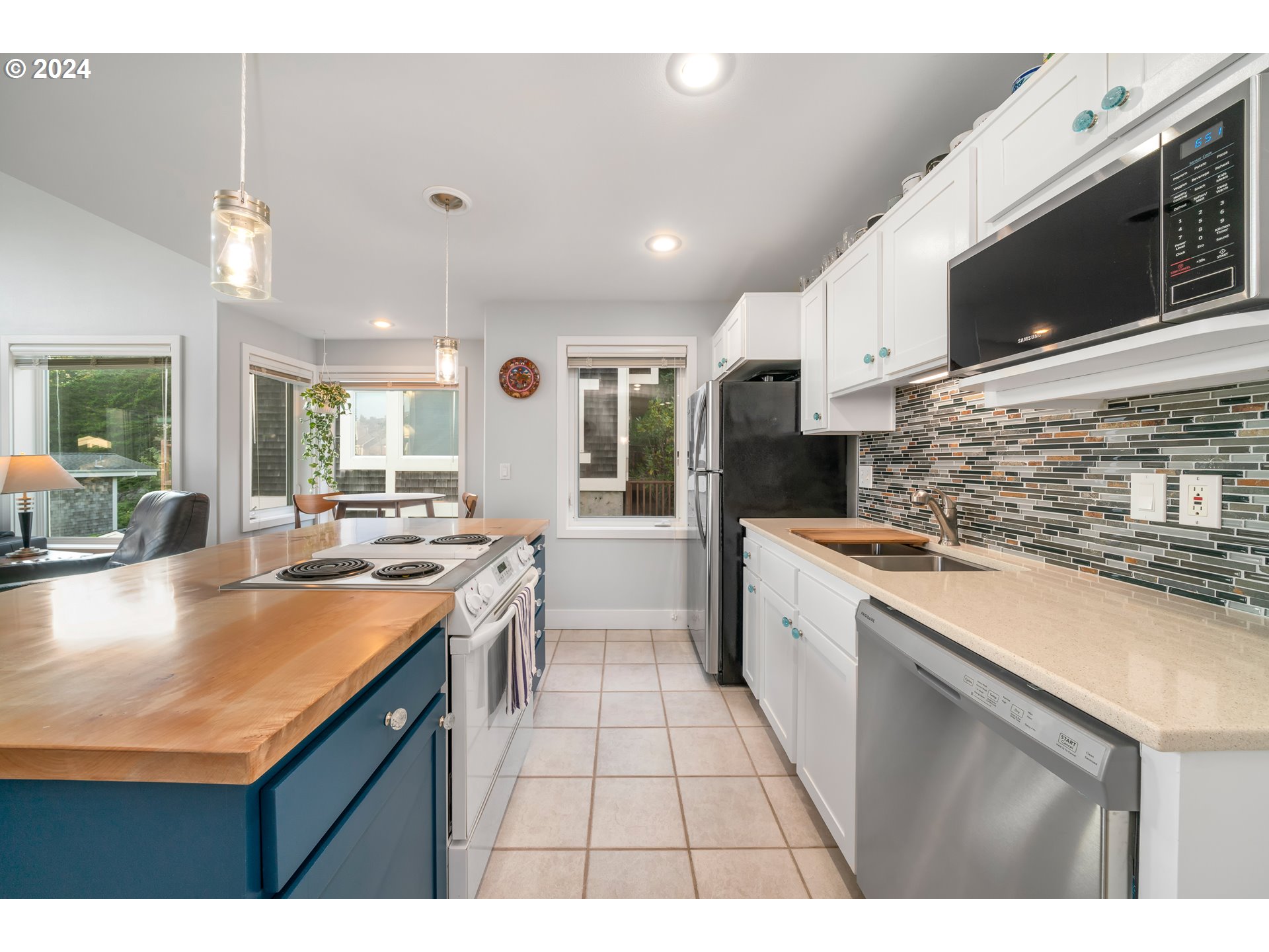 505 Capes Drive, Unit 5 Oceanside, OR 97141 - Photo 10 of 37 a kitchen with stainless steel appliances kitchen island granite countertop a sink and cabinets