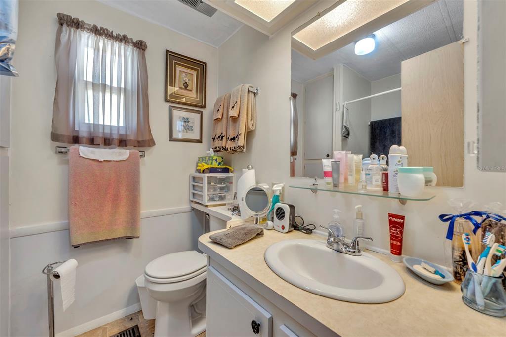 223 Paradise Leesburg, FL 34788 - Photo 22 of 43 a bathroom with a sink toilet and mirror