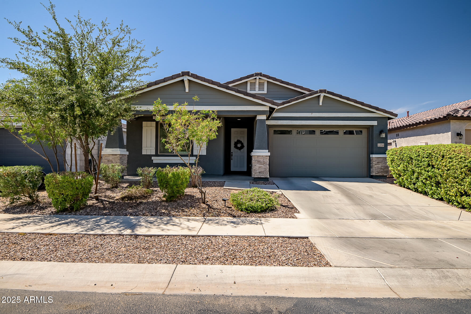 a front view of a house with garden