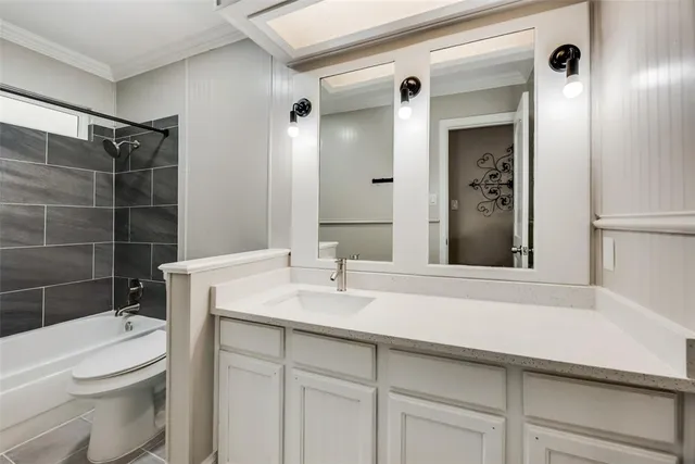a bathroom with a sink toilet vanity and shower