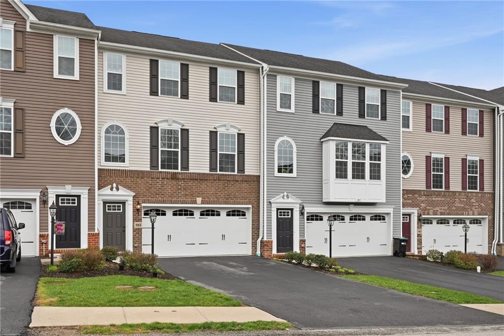 a front view of a house with a garden and plants