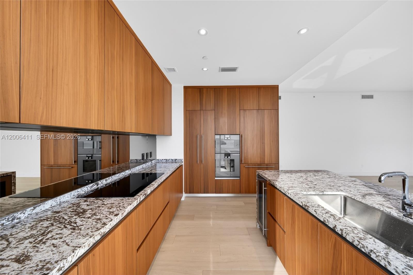 175 Southeast 25th Road, Unit 1202 Miami, FL 33129 - Photo 11 of 74 a large kitchen with kitchen island granite countertop a sink and a stove