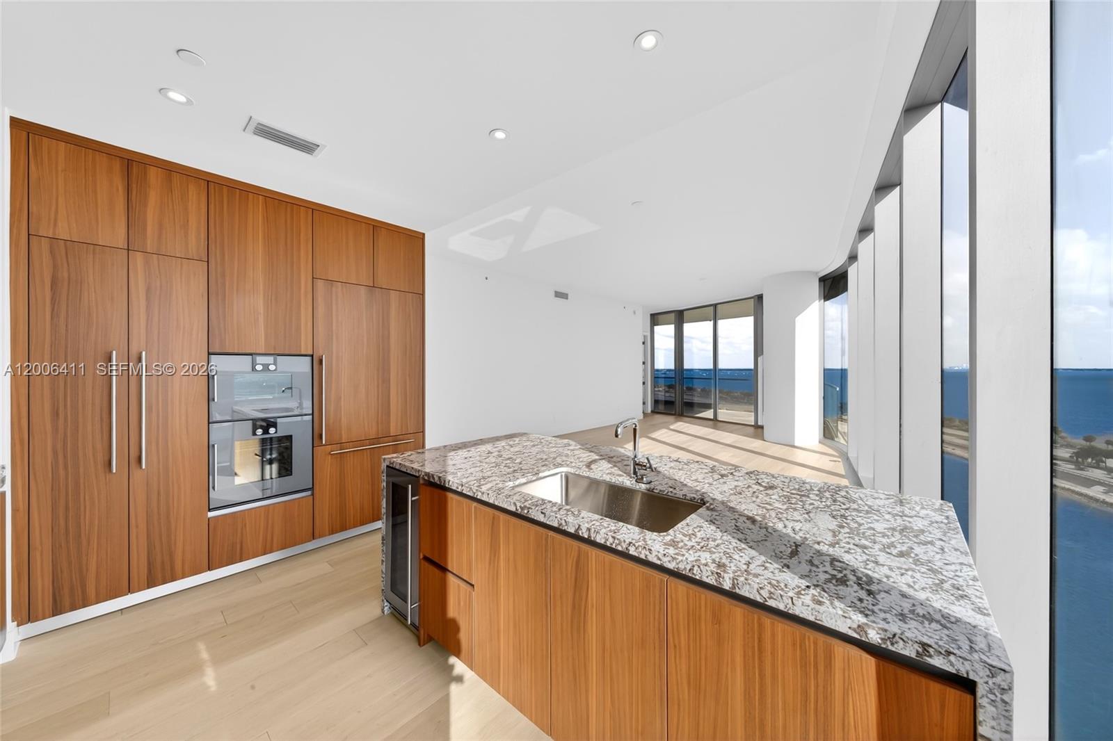 175 Southeast 25th Road, Unit 1202 Miami, FL 33129 - Photo 12 of 74 a kitchen with granite countertop cabinets and refrigerator