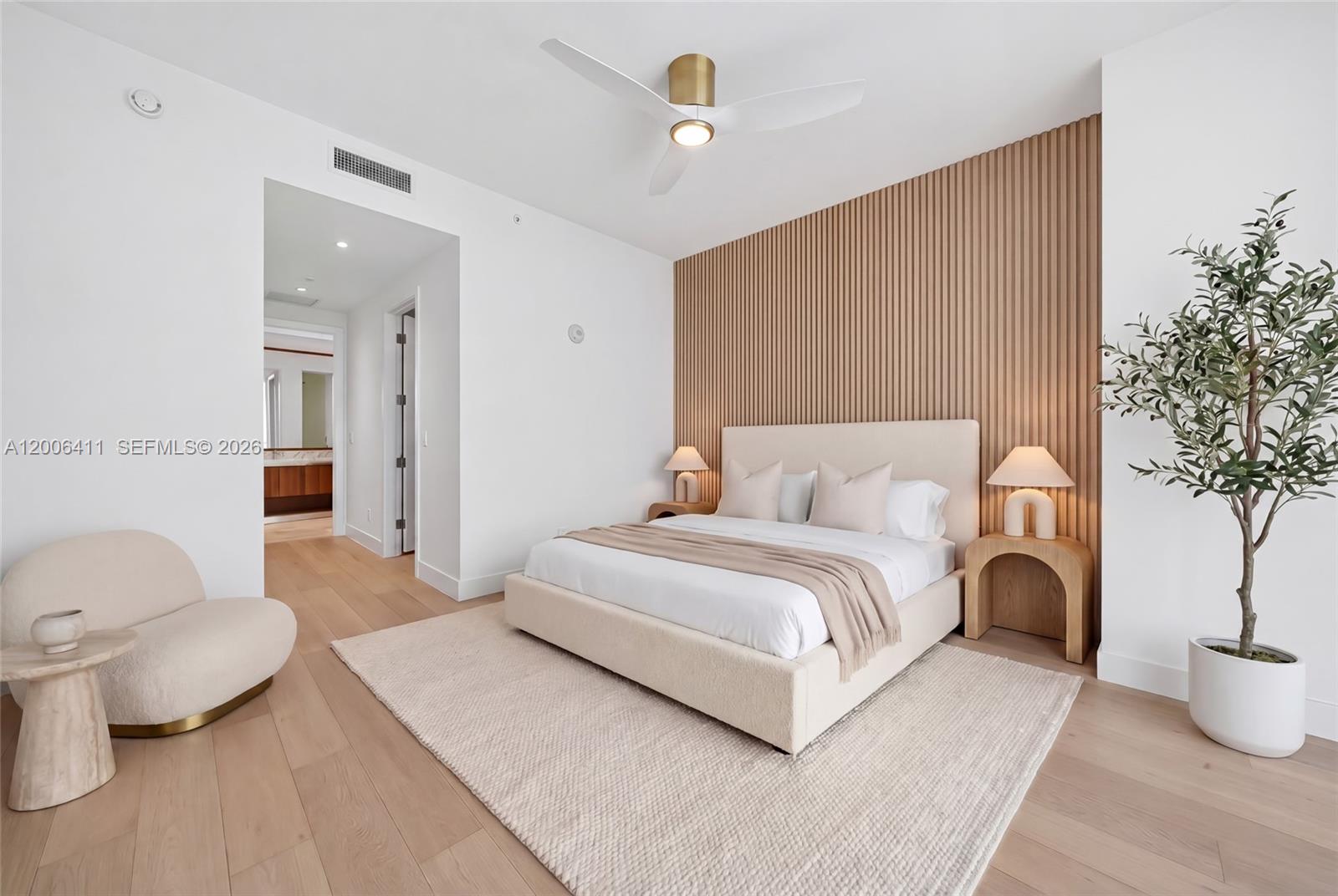 175 Southeast 25th Road, Unit 1202 Miami, FL 33129 - Photo 19 of 74 a spacious bedroom with a bed and a potted plant