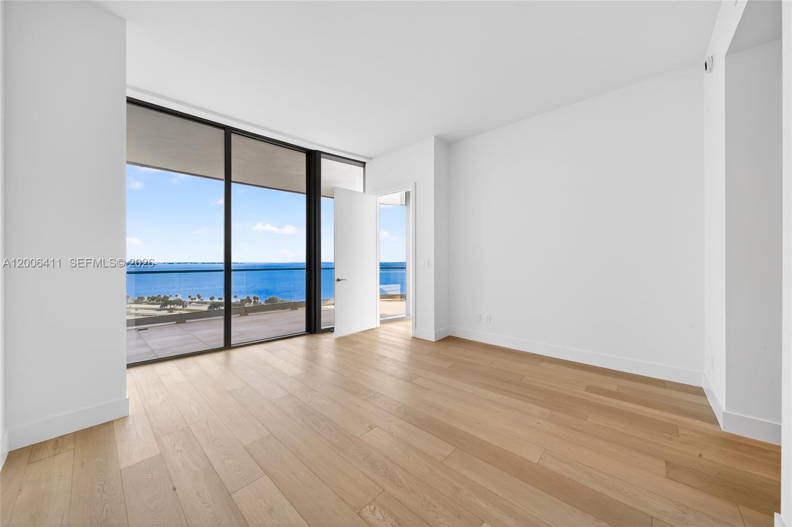 175 Southeast 25th Road, Unit 1202 Miami, FL 33129 - Photo 20 of 74 a view of an empty room with wooden floor and a window