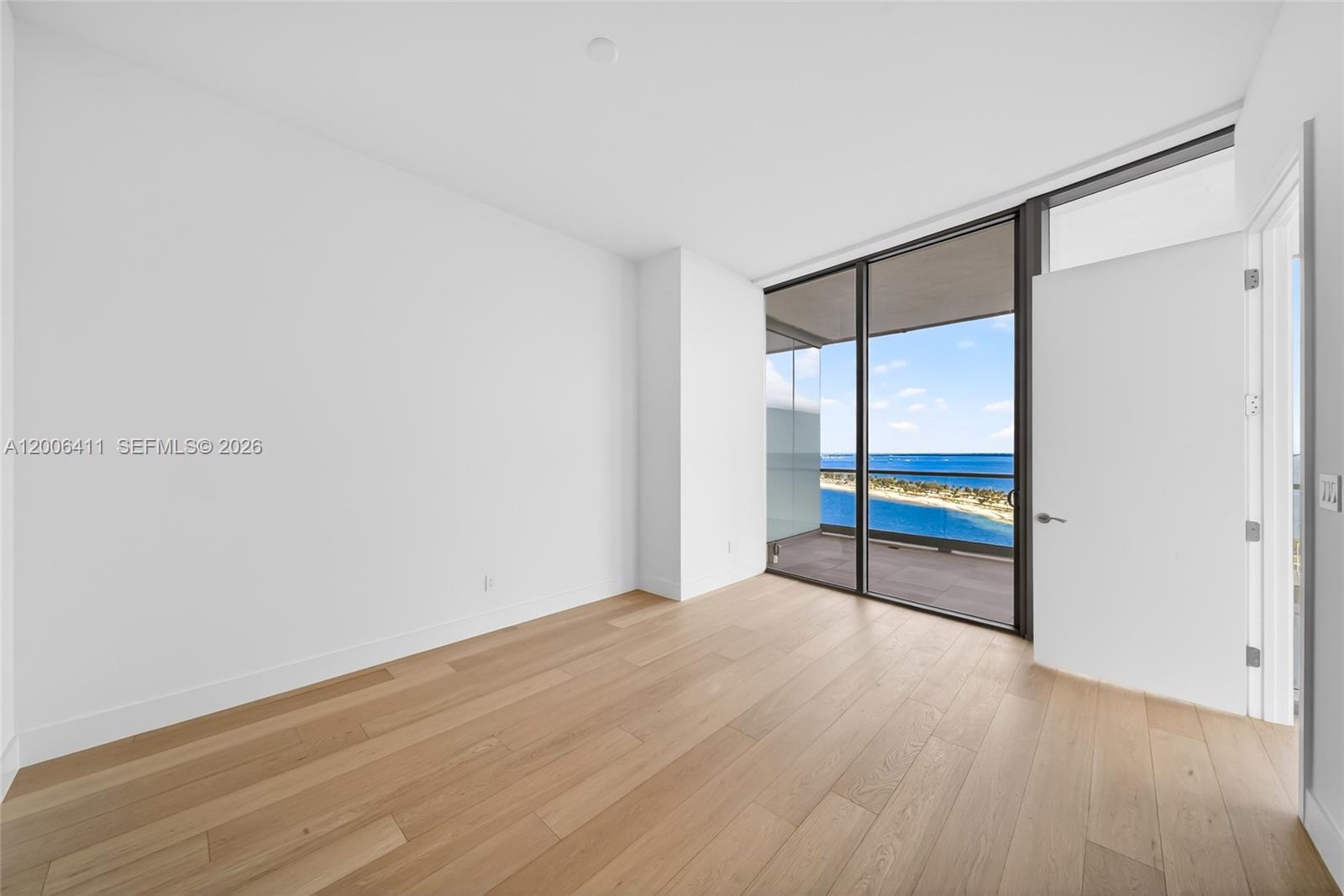 175 Southeast 25th Road, Unit 1202 Miami, FL 33129 - Photo 23 of 74 a view of an empty room with wooden floor and a window