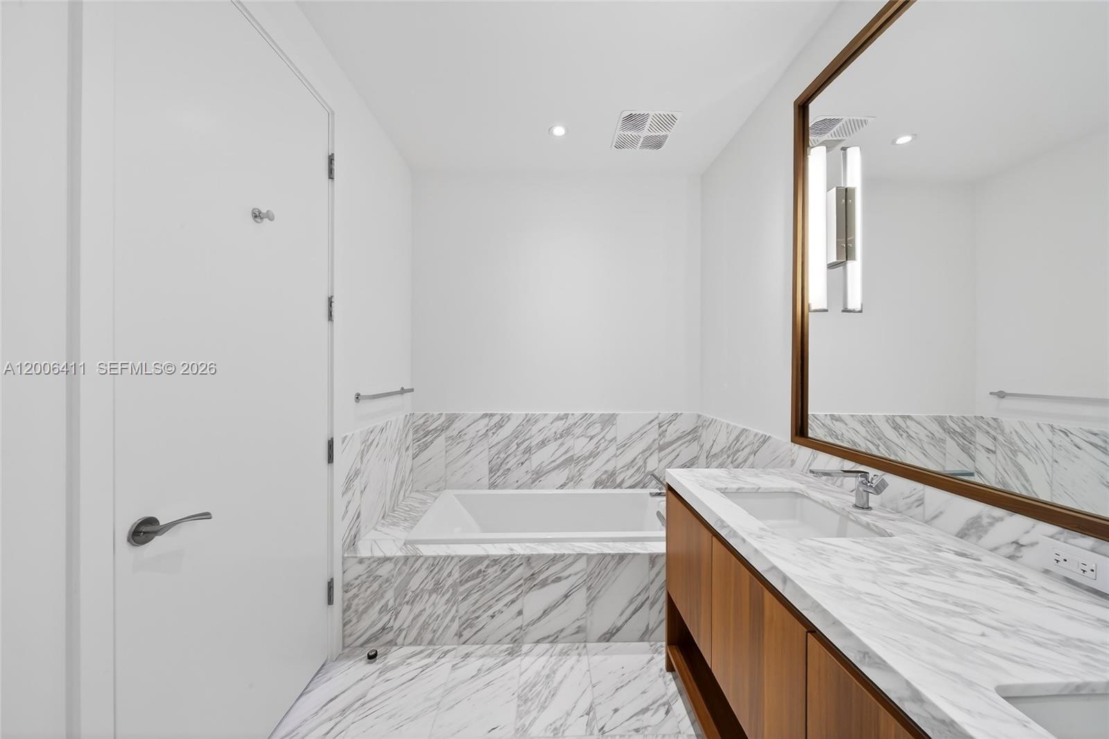 175 Southeast 25th Road, Unit 1202 Miami, FL 33129 - Photo 26 of 74 a bathroom with a granite countertop sink and a mirror