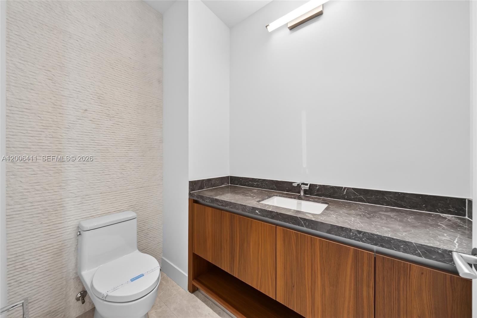 175 Southeast 25th Road, Unit 1202 Miami, FL 33129 - Photo 32 of 74 a bathroom with a granite countertop sink and a toilet