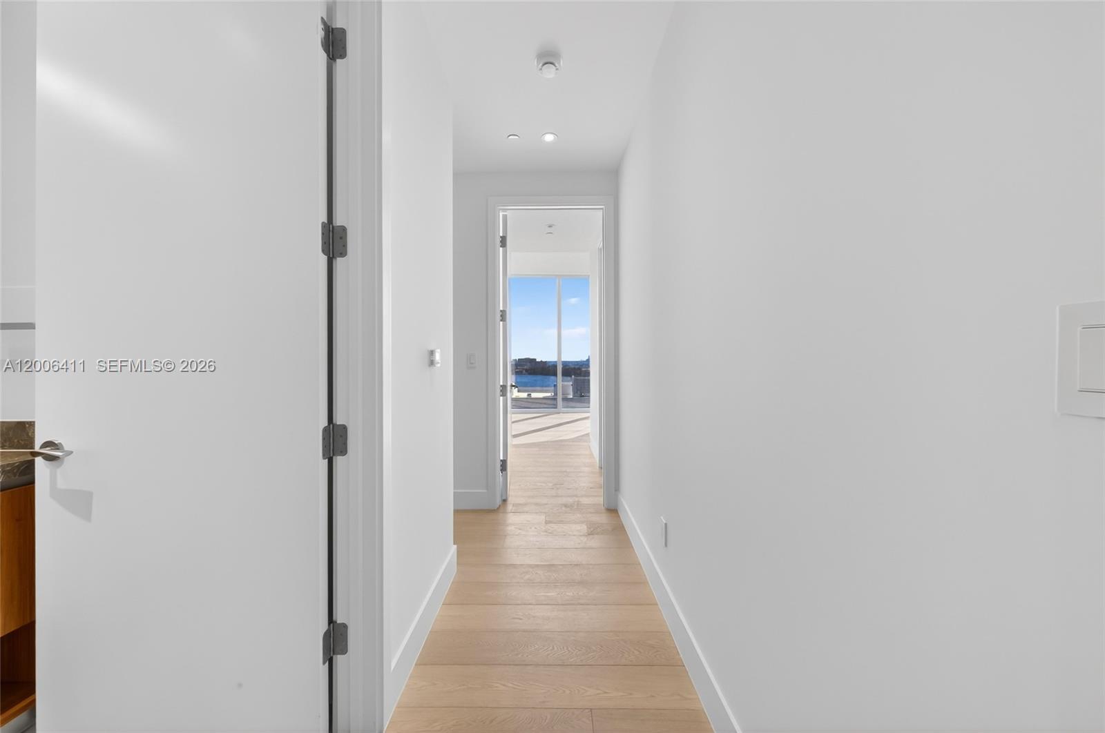 175 Southeast 25th Road, Unit 1202 Miami, FL 33129 - Photo 34 of 74 a view of a hallway with wooden floor and a bathroom