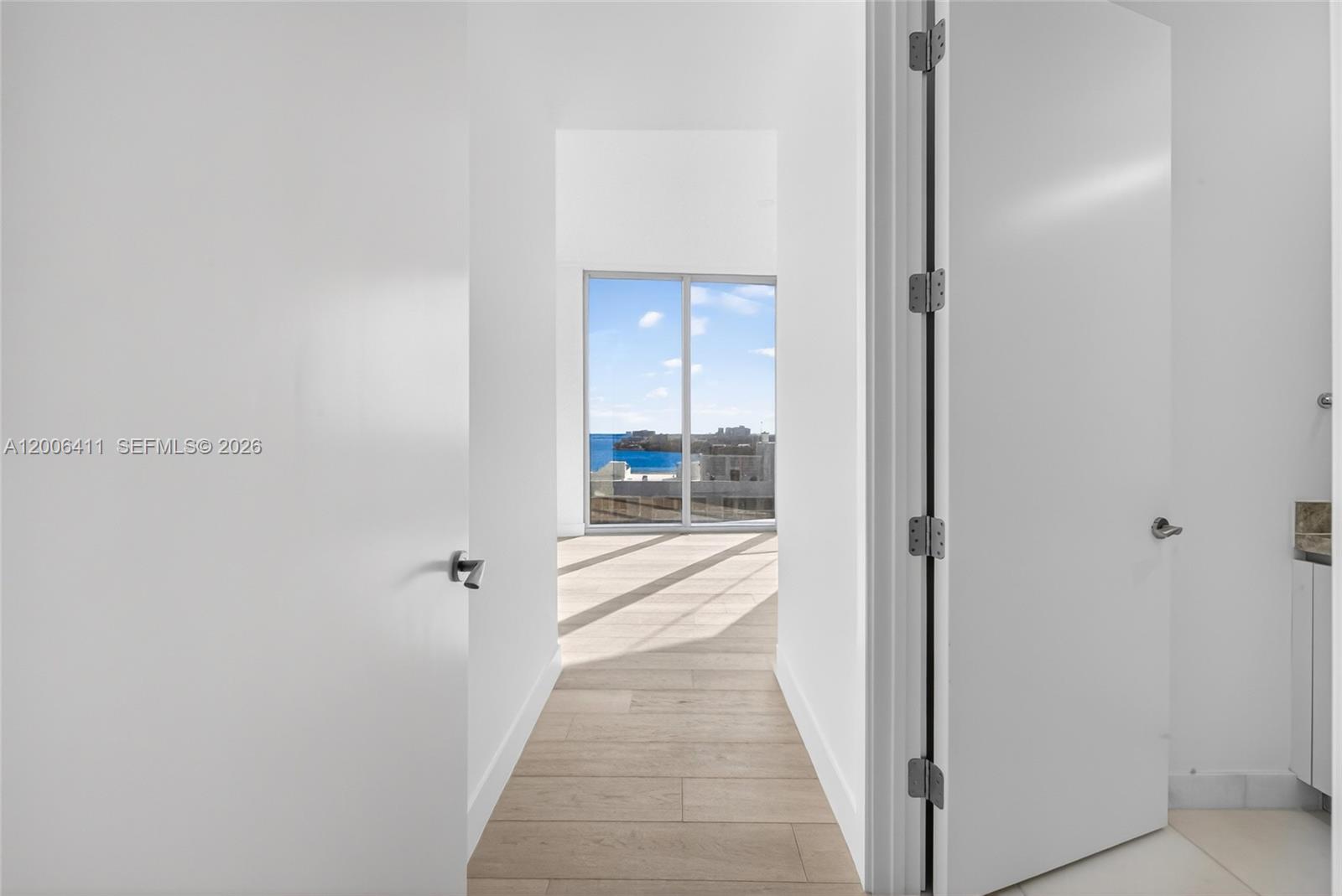 175 Southeast 25th Road, Unit 1202 Miami, FL 33129 - Photo 35 of 74 a view of a hallway with wooden floor and a bathroom