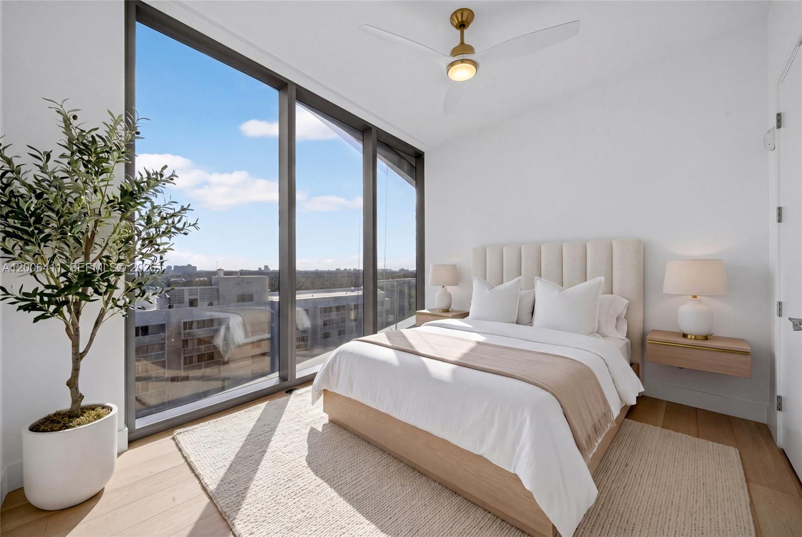175 Southeast 25th Road, Unit 1202 Miami, FL 33129 - Photo 38 of 74 a bedroom with a large bed and a potted plant