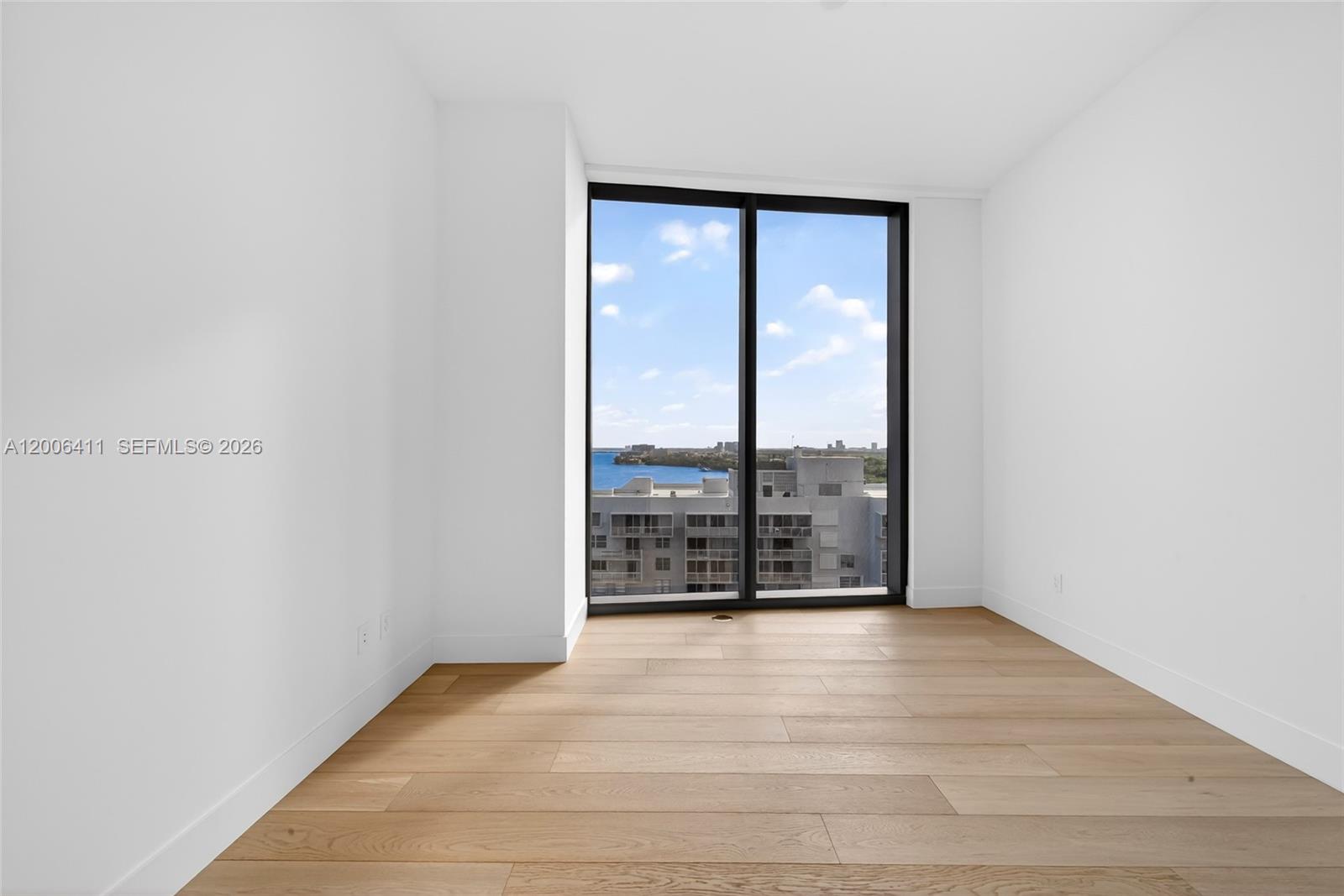 175 Southeast 25th Road, Unit 1202 Miami, FL 33129 - Photo 41 of 74 a view of an empty room with wooden floor and a window