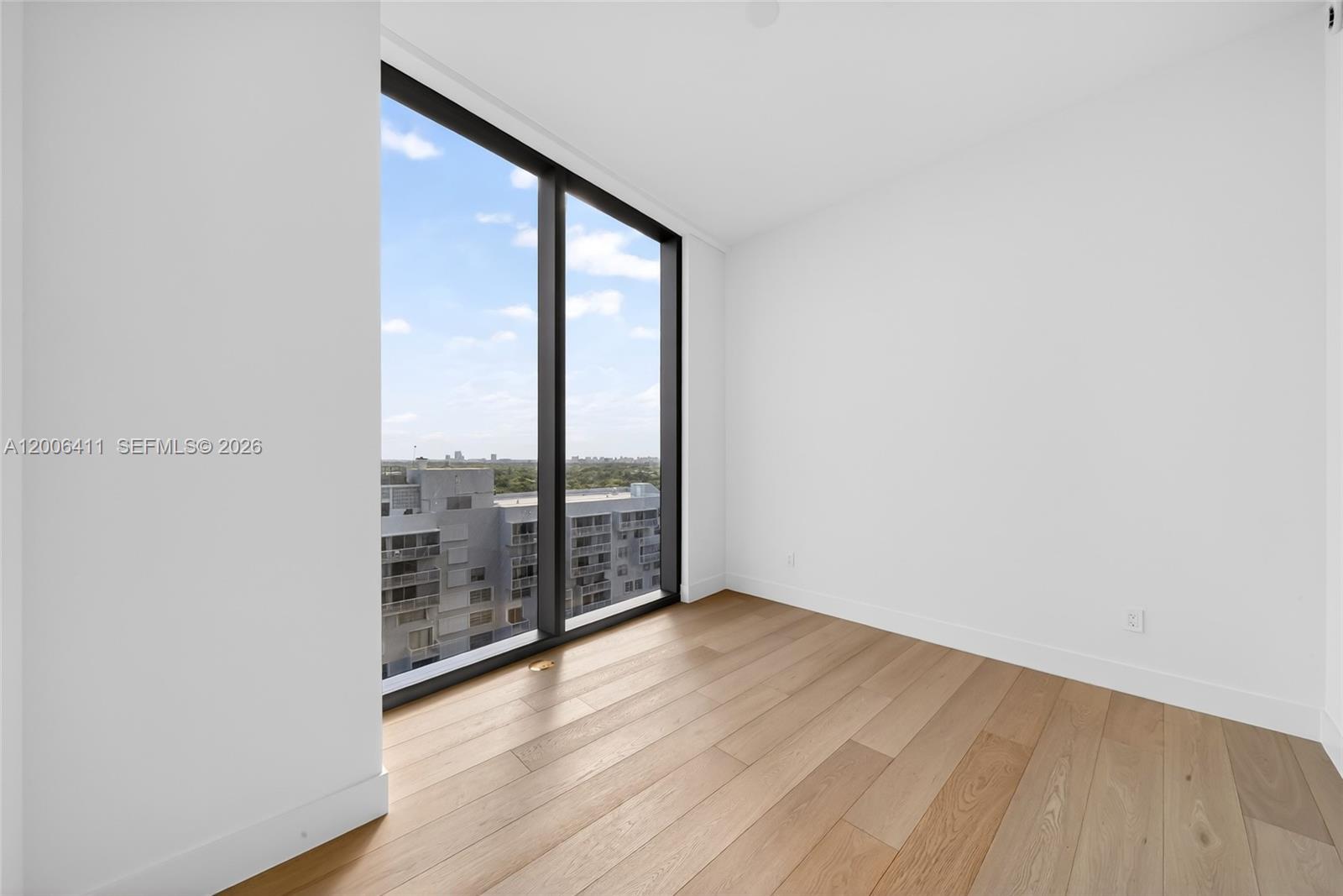 175 Southeast 25th Road, Unit 1202 Miami, FL 33129 - Photo 42 of 74 wooden floor in an empty room with a window