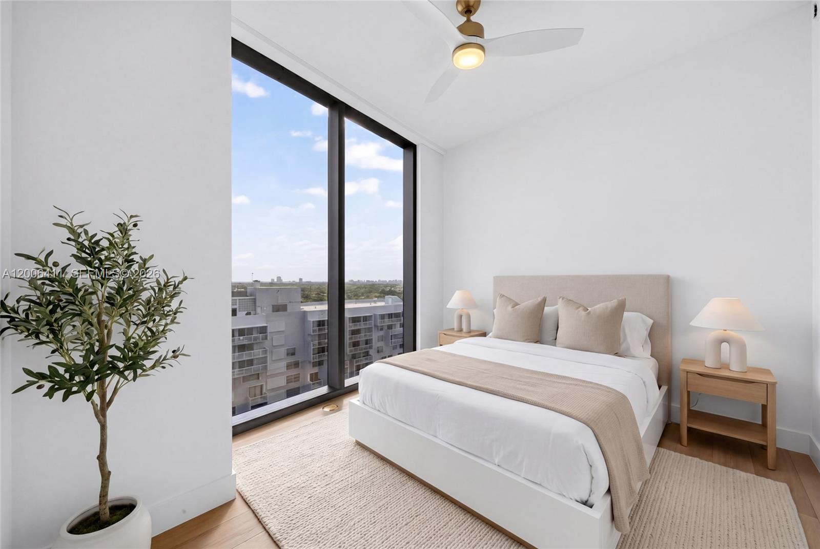 175 Southeast 25th Road, Unit 1202 Miami, FL 33129 - Photo 43 of 74 a bedroom with a large bed and a potted plant