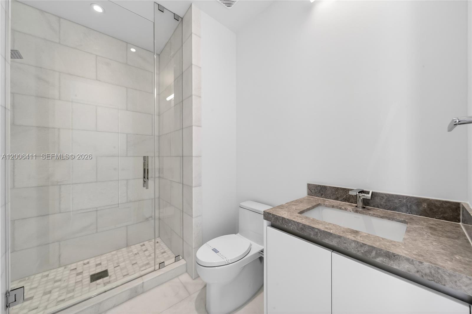 175 Southeast 25th Road, Unit 1202 Miami, FL 33129 - Photo 45 of 74 a bathroom with a granite countertop sink toilet and shower