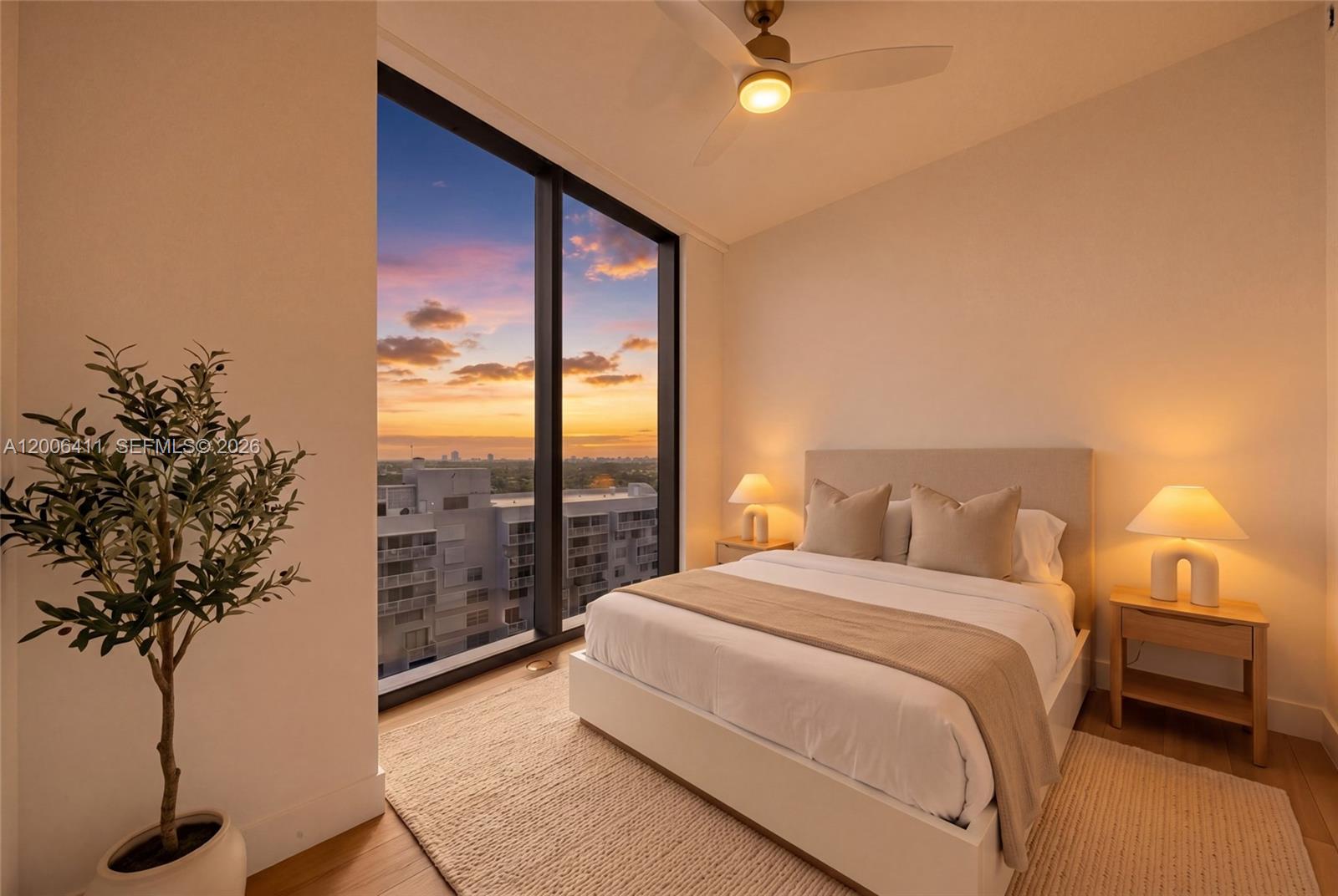 175 Southeast 25th Road, Unit 1202 Miami, FL 33129 - Photo 49 of 74 a bedroom with a large bed and a potted plant