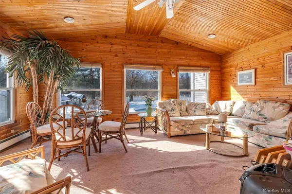 a view of a patio with dining table and chairs with wooden floor