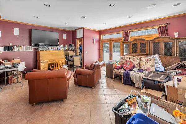 a living room filled with furniture and a kitchen area