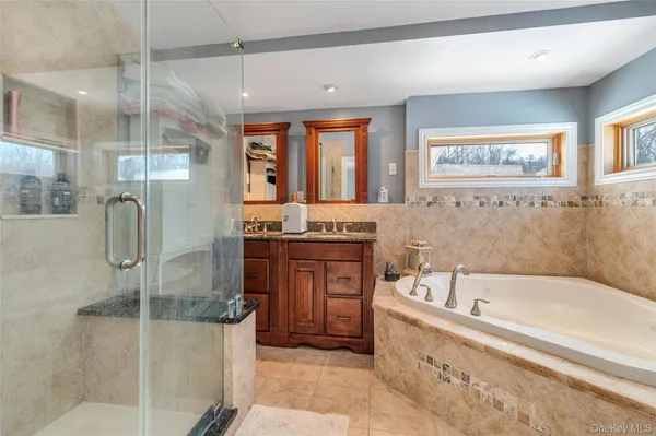 a bath room with a bath tub and a shower