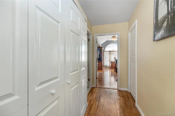 a view of a hallway with wooden floor