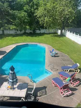 a view of a backyard with table and chairs