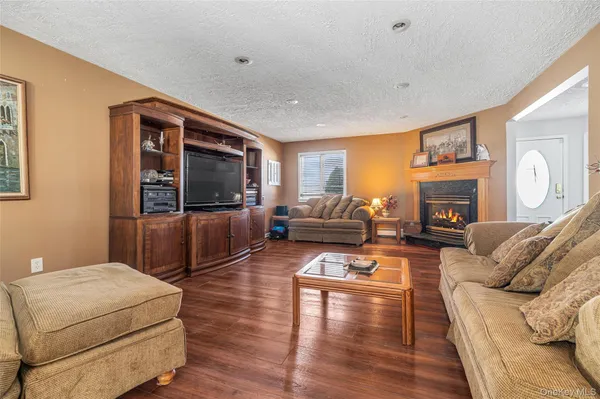 a living room with furniture flat screen tv and fireplace